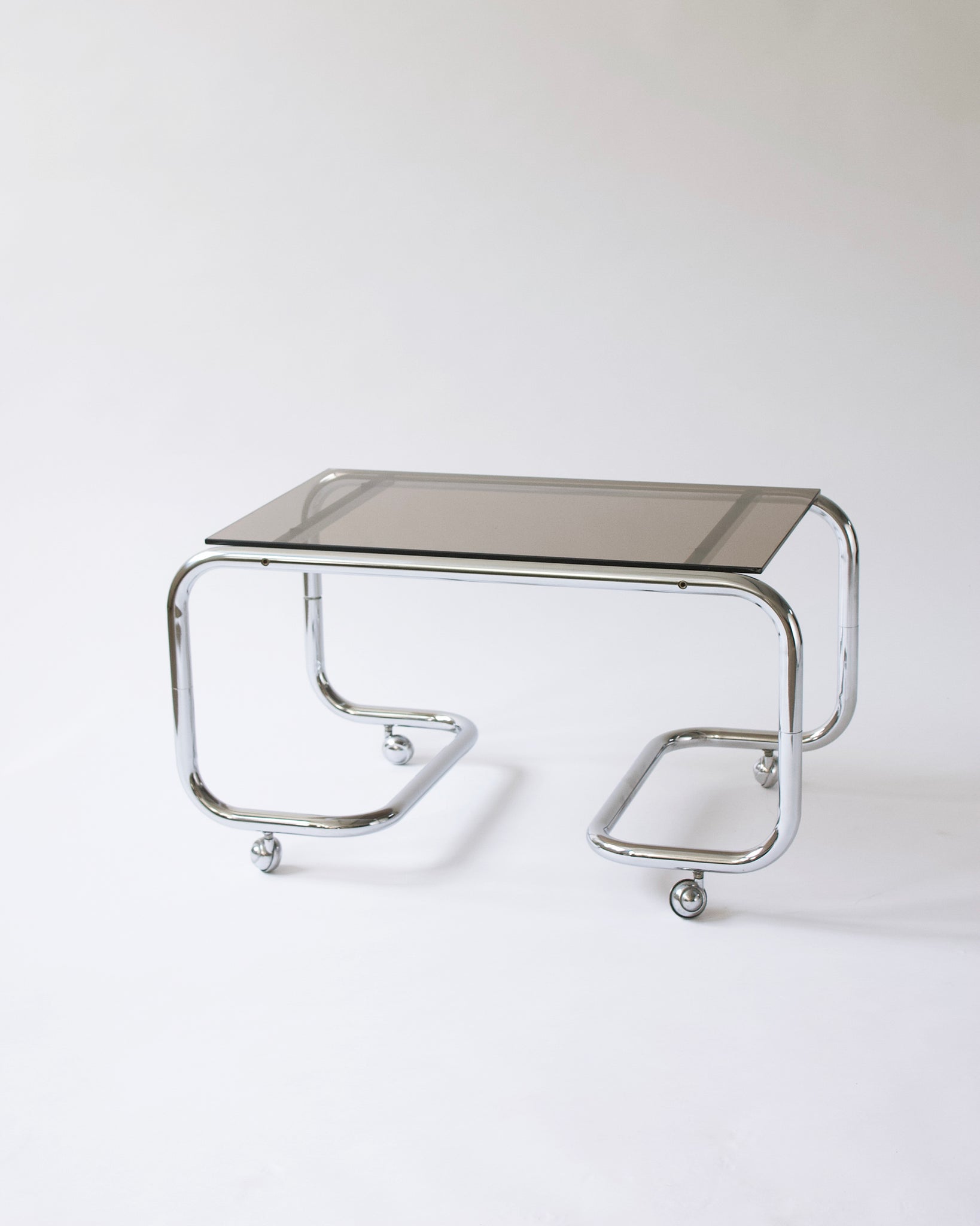Couchtisch Vintage 70er Rauchglas Chrom Stahlrohr auf Rollen